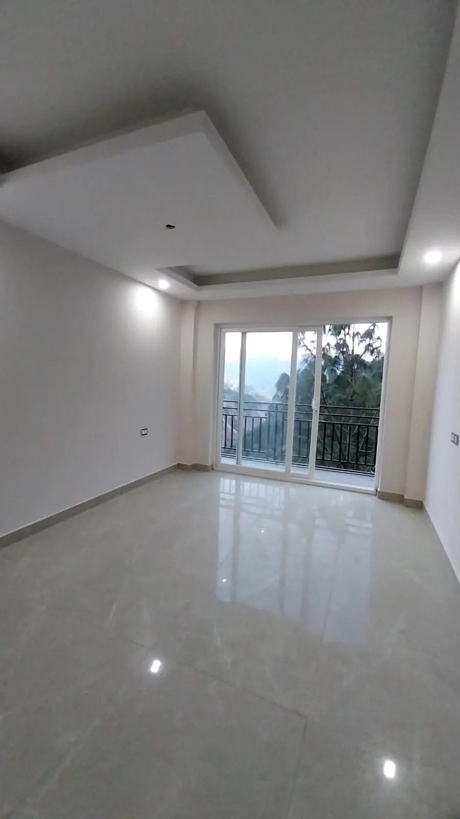Bedroom sliding door opening to a forest view