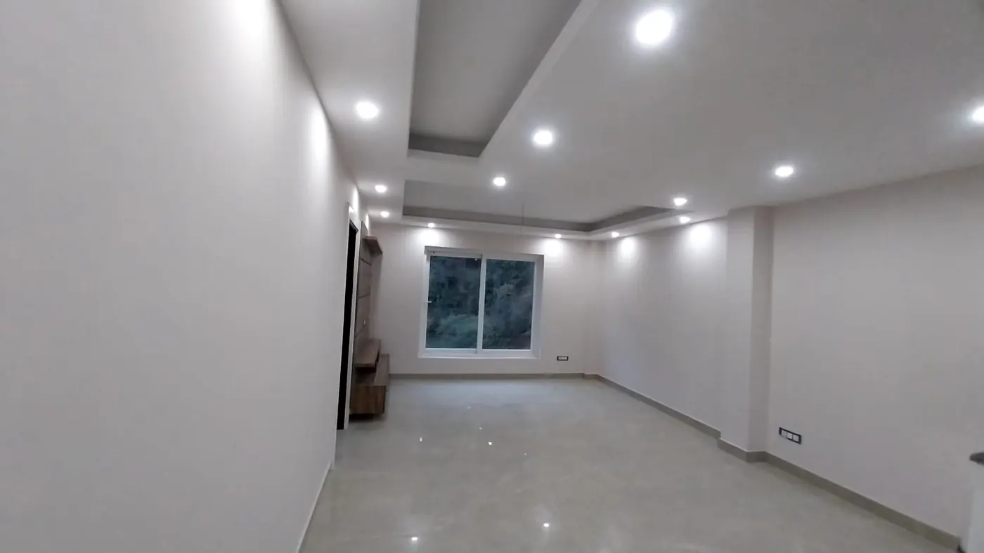 Living room with false ceiling and large window