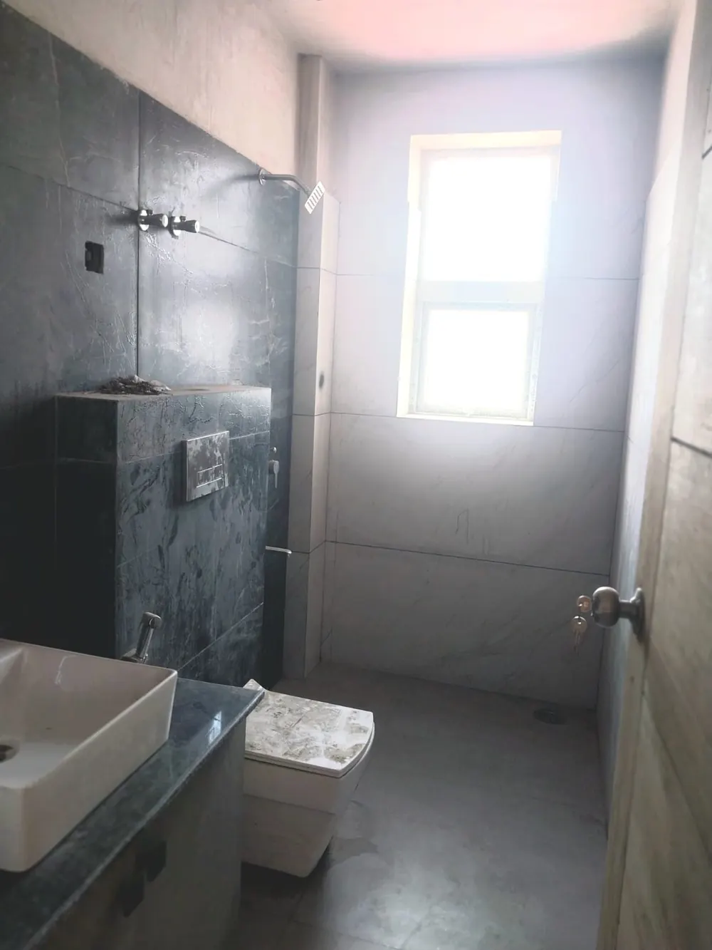 Bathroom with dark stone wall during finishing