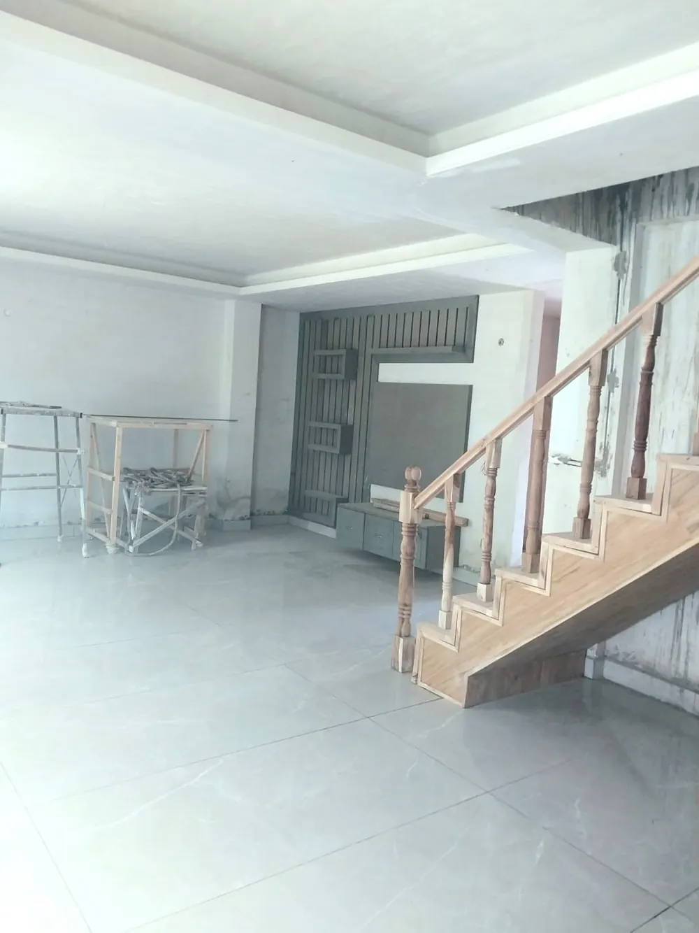 Duplex living room with staircase during finishing