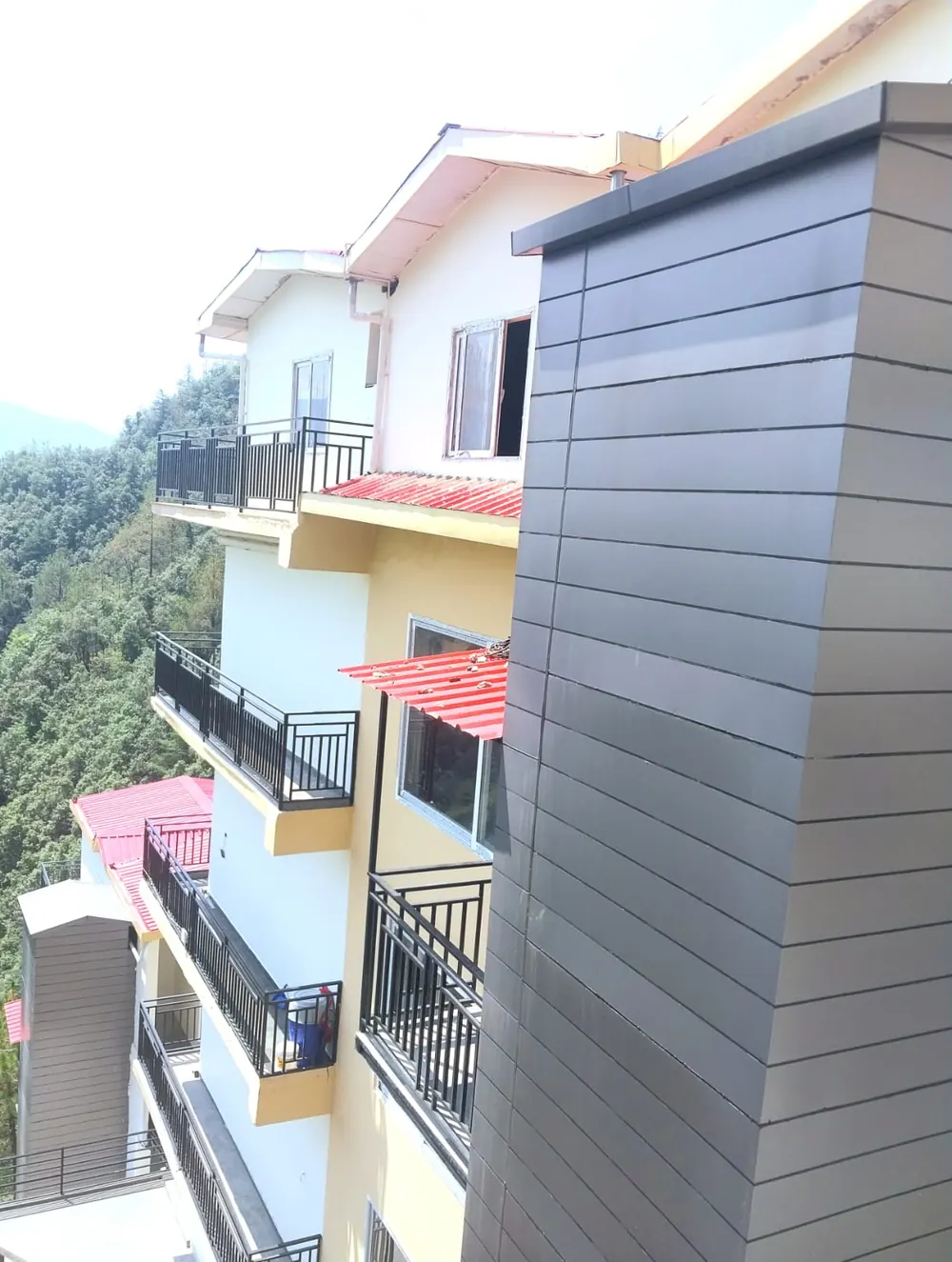 Exterior with clad lift shaft and balconies