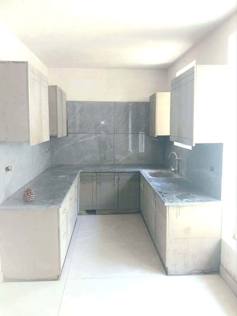 U-shaped kitchen with stone counters