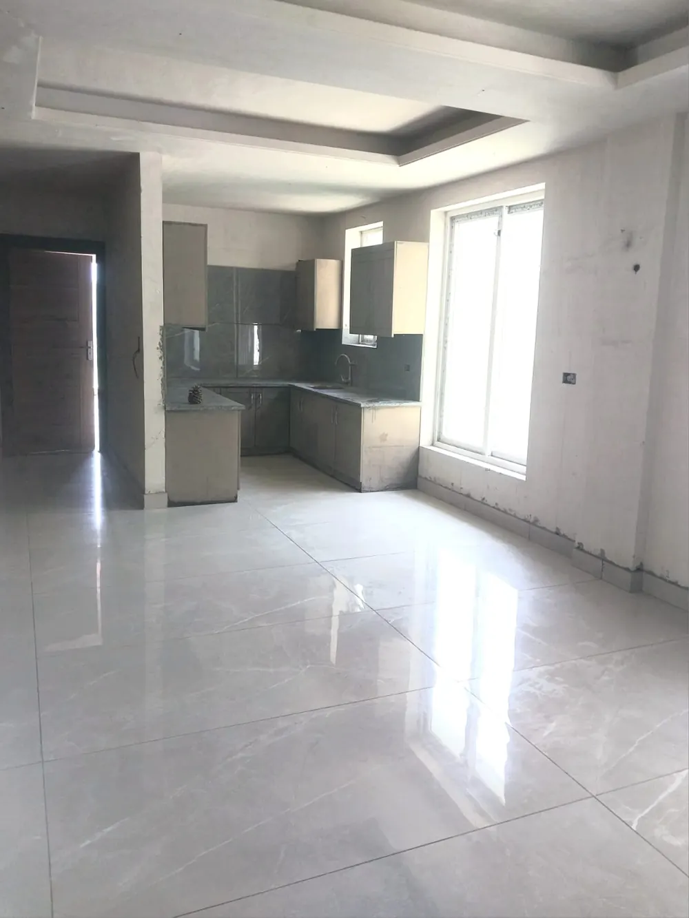 Open-plan living and kitchen with large window